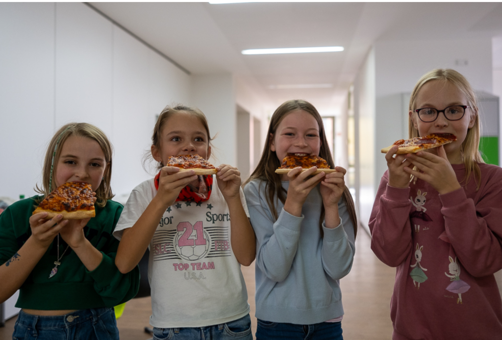 Schülerinnen beim Pizza essen