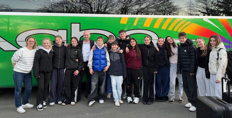 Gruppenfoto der Schülerinnen und Schüler vor dem Reisebus
